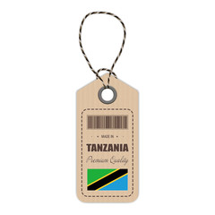Hang Tag Made In Tanzania With Flag Icon Isolated On A White Background. Vector Illustration. Made In Badge. Business Concept. Buy products made in Tanzania. Use For Brochures, Printed Materials