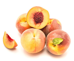 Group of peaches, whole with a green leaf, one half with a stone, one slice, isolated on white background.