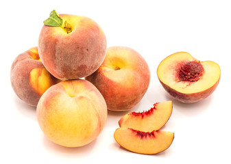 Whole and sliced peaches composition isolated on white background.