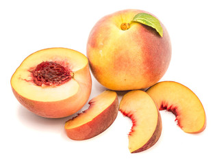 Group of peaches, whole with a green leaf, one half with a stone, isolated on white background.