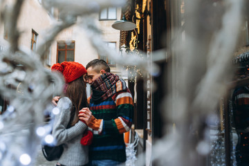 Young couple outside in winter christmas decoration