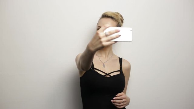 Young blonde woman doing selfie. Loop