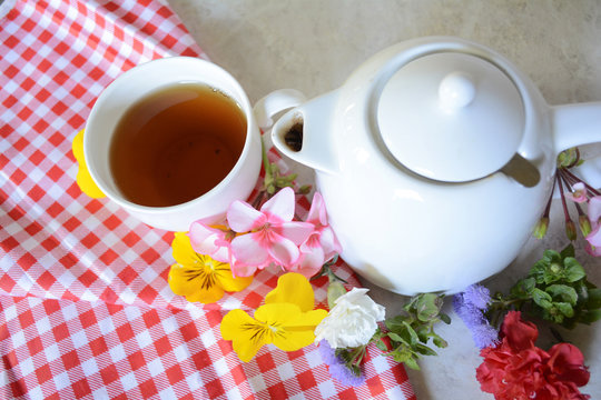 Cup of tea among the different colors collected in the spring blooming garden creates a mood