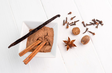 cinnamon, nutmeg and vanilla on a white background