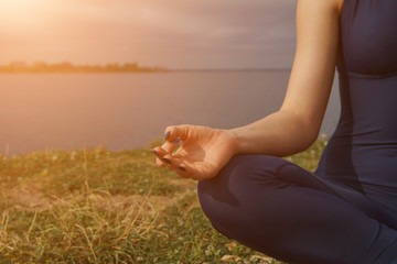Close up hands. Woman do yoga outdoor.