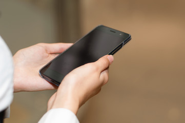 Woman using her smart phone outside