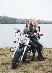 Fototapeta na wymiar Couple on a bike in a leather jackets