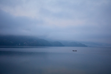 Colored boats on the water on a lake in Nepal