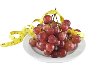 fresh red grapes in dish isolated on over white background with clipping path.