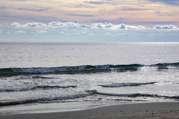 Clouds, sky and surf on the Bay of Alassio, Italy.