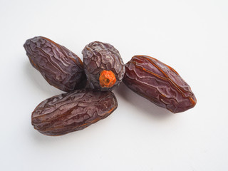 Delicious fresh organic dates over white background
