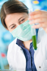 Girl laboratory assistant in the chemical laboratory of the university experiment with chemical reagents