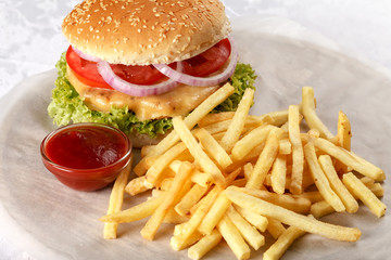 Fresh cheeseburger with French fries and tomato sauce