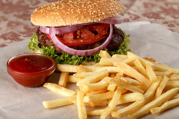Fresh hamburger with French fries and tomato sauce