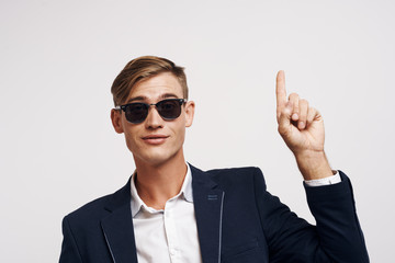 young guy in suit shows thumb up