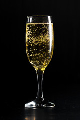glass of champagne on black background