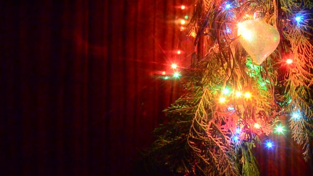 Christmas lights on a tree in different colors are classic symbol of Christmas.