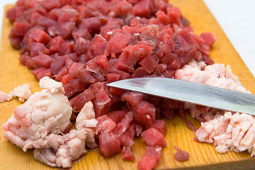 cut meat on wooden hardboard