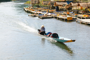 Fototapeta premium The fisherman is riding a motor boat on the river at Vang vieng, Laos 