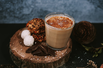 Hot cappuccino on rustic background