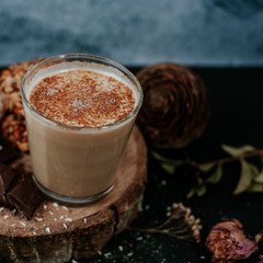 Hot cappuccino on rustic background