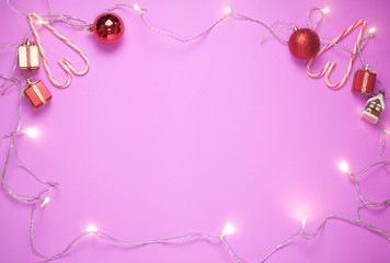 Top view of minimal Christmas decoration light on pink color background