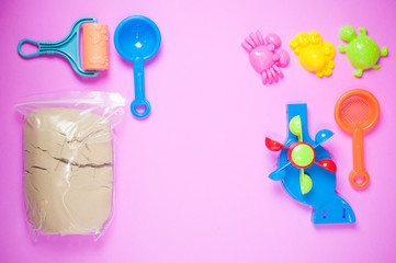 Top view of plastic sand toy on pink background