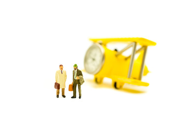 Miniature people,couple businessman standing with air plane isolated on white background using as business concept