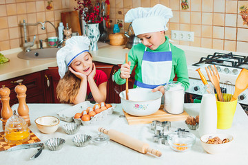 happy family funny kids are preparing the dough, bake cookies in the kitchen