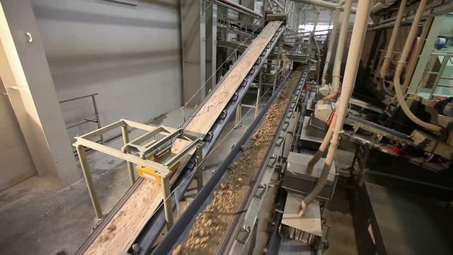 Сonveyor belt on factory, Ceramic factory equipment, Transportation of clay on the conveyor, industrial interior, Transportation of raw materials on the conveyor