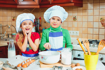 happy family funny kids are preparing the dough, bake cookies in the kitchen