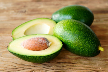 Group of fresh avocado on a wooden rustic table. Food concept