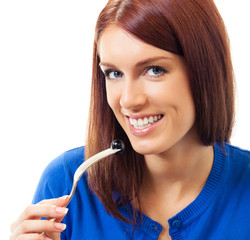 Woman eating black olive, over white