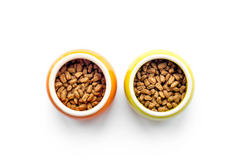 Pet food in bowl on white background top view copyspace