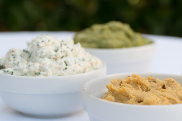 Hummus, cheese and guacamole dip bowls