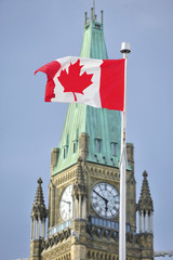 Parliament building  clock tower with flag of Canada