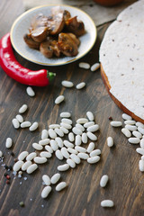 Dry white kidney beans on wooden table