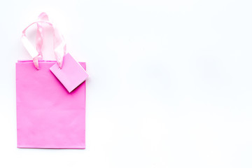 Pink shopping bag on white background top view copyspace
