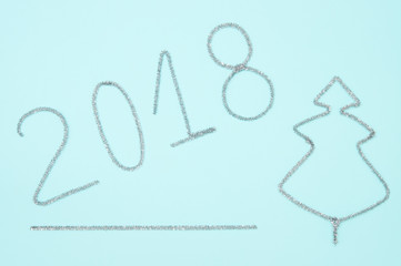 Figures from 2018 ornaments on the pale blue background. Happy new year.