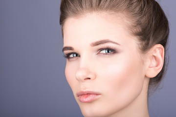 Fototapeta premium Closup portrait of a young woman. Nude makeup