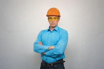 Professional engineer worker in a helmet holding his hands crossed isolated. Construction people.