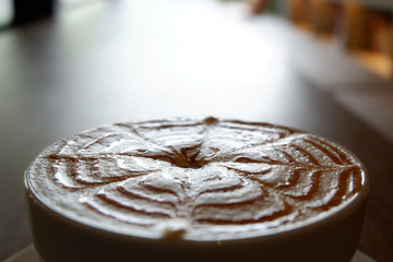 Cup of coffee latte art on wooden background