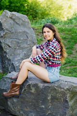 Girl on a big stone in the park