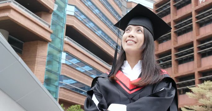Young Asian cheerful graduation looking at the top