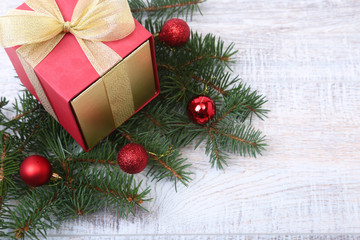 Fototapeta na wymiar Christmas fir tree with gift box on wooden board