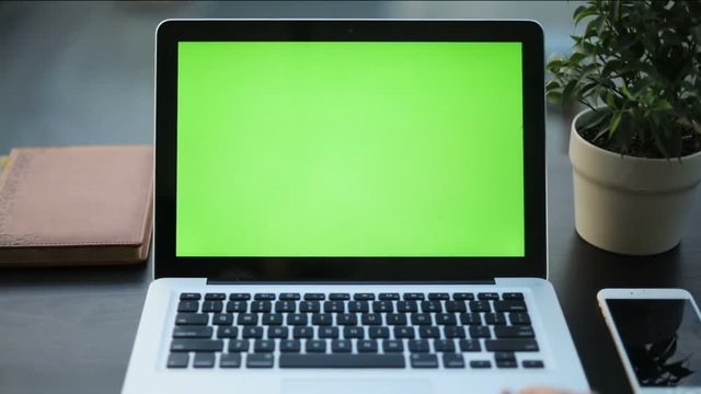 top view woman hands using touchpad notebook close up green screen chromakey mock-up finger clicking button Enter trendy technology development network business communication office smart phone table