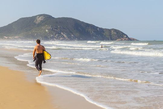Surfer in Costao do Santinho beach