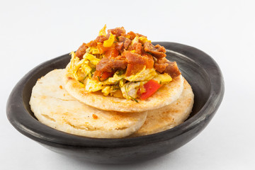 Traditional Colombian arepa topped with chicken breast and pork rind