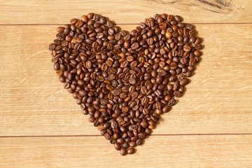 Grains of invigorating coffee on a wooden table