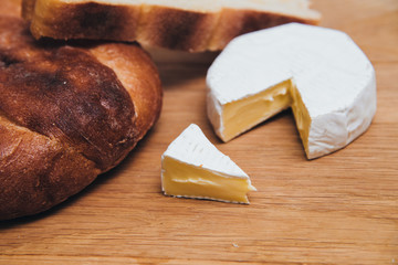 Bread with chees camembert on wood table